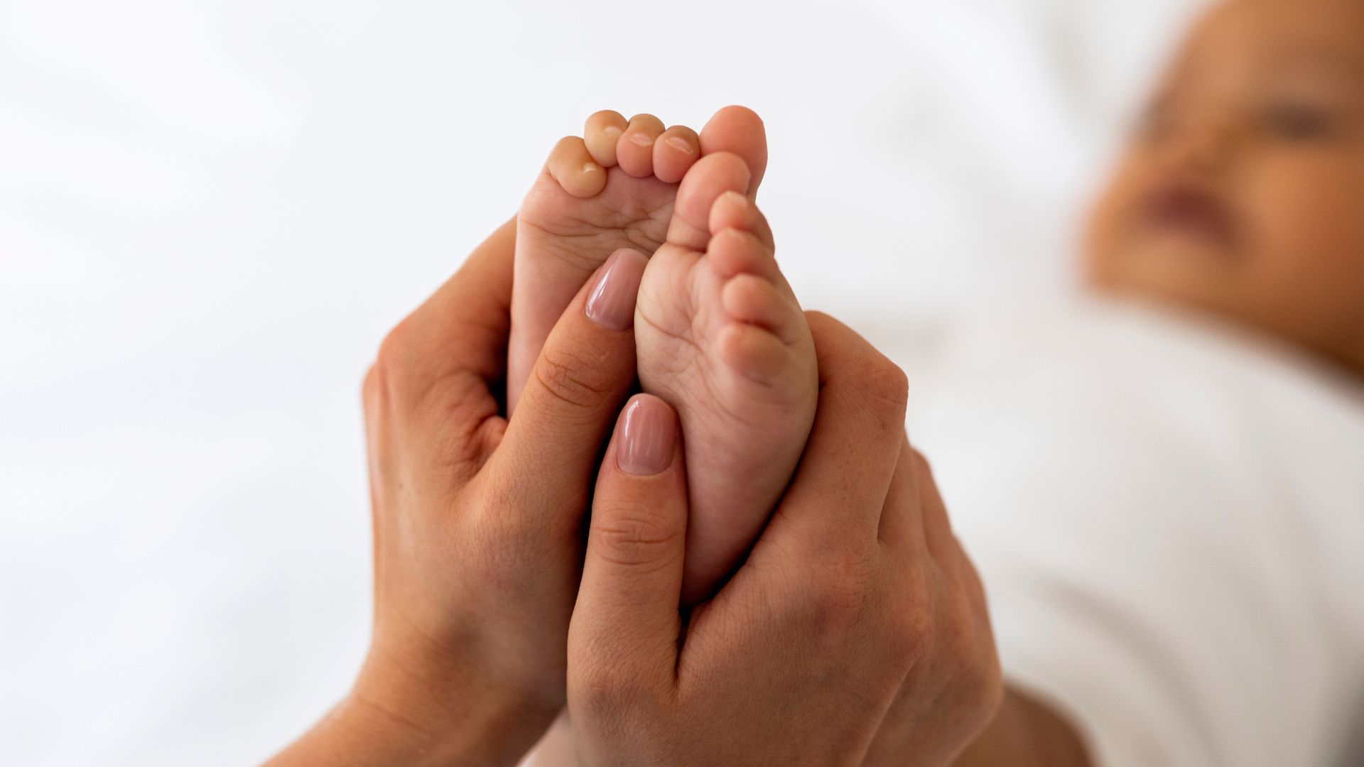 Heart-shaped hands over pregnant belly — love and connection