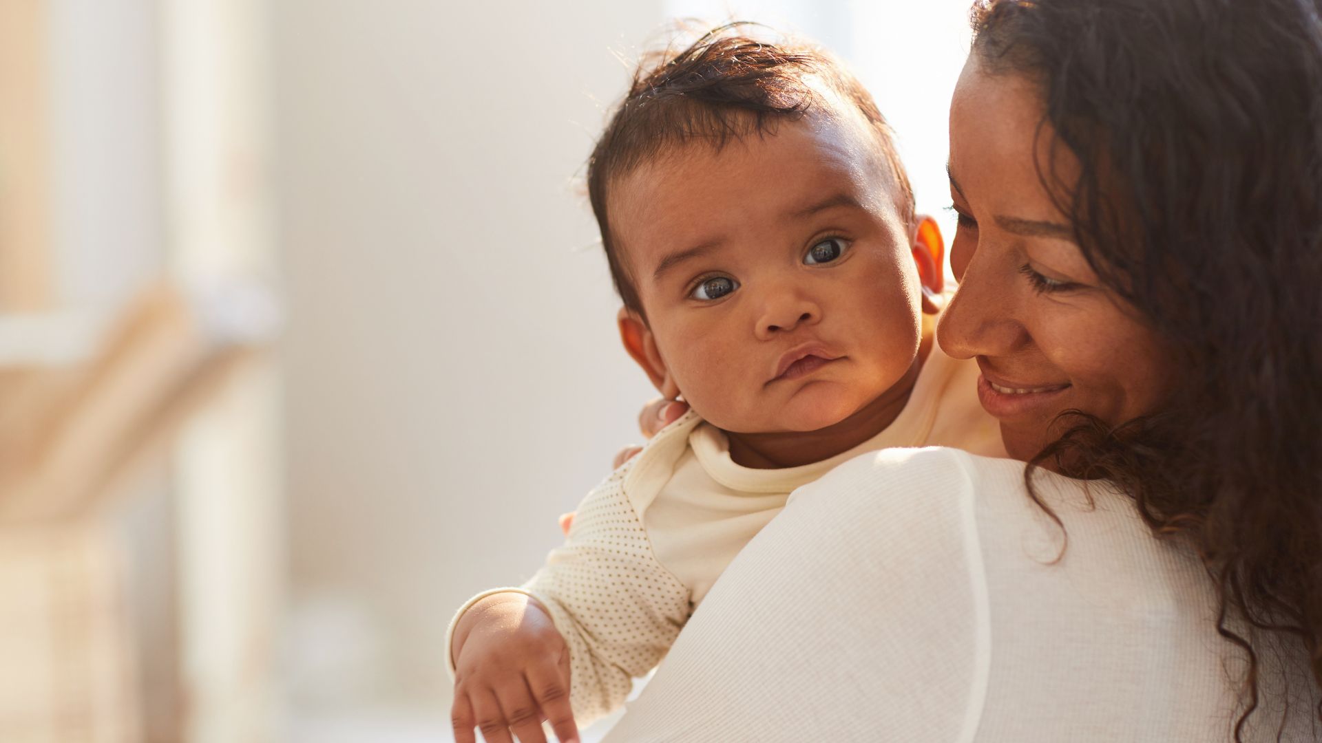 Mother tenderly holding her newborn baby